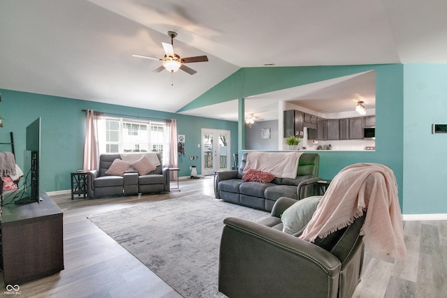 6190 E Ayrshire Cir, Camby, IN 46113 - living area with ceiling fan, lofted ceiling, light wood finished floors, and baseboards