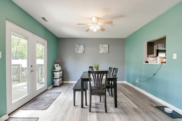 6190 E Ayrshire Cir, Camby, IN 46113 - dining space featuring french doors, a ceiling fan, light wood-style flooring, and baseboards