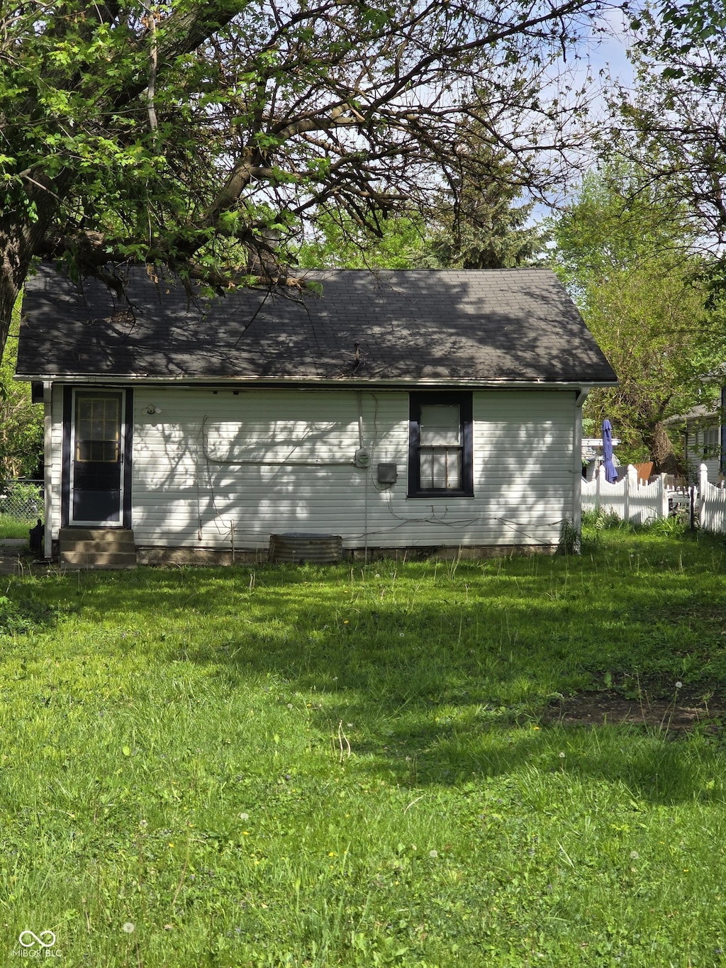 view of side of property with a lawn and entry steps