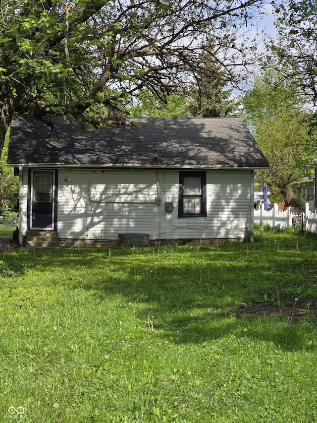 view of side of property with a lawn and entry steps
