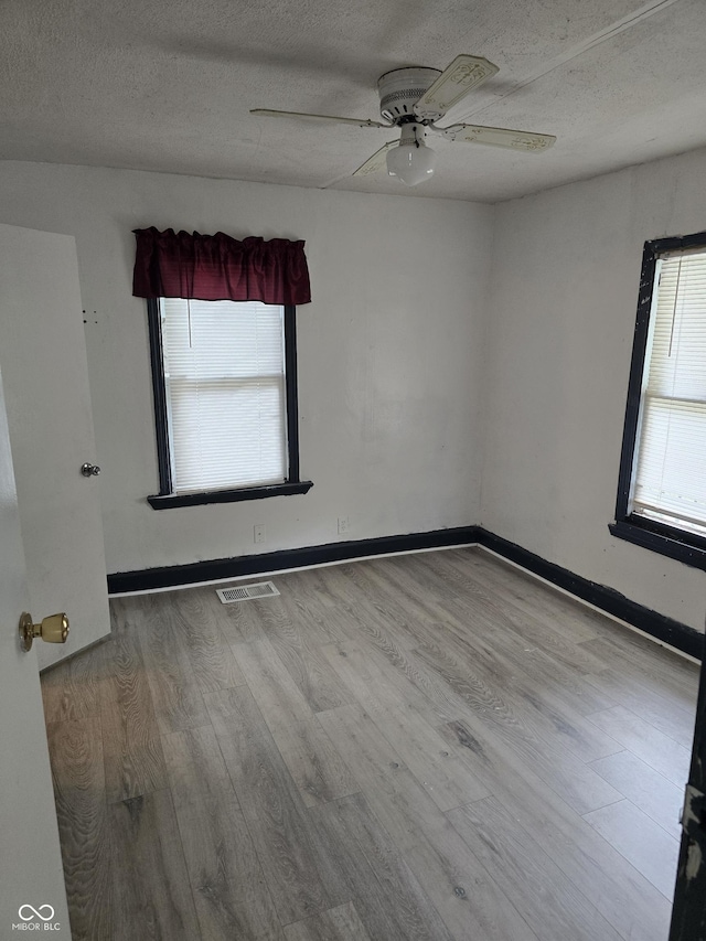 114 S Catherwood Ave, Indianapolis, IN 46219 - unfurnished room featuring wood finished floors, a textured ceiling, a ceiling fan, and baseboards