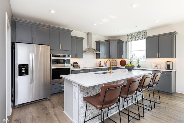 175 Rock Island Rd, Westfield, IN 46074 - kitchen with stainless steel appliances, wall chimney exhaust hood, a sink, light wood-style floors, and recessed lighting