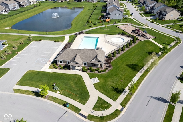 aerial view of residential area featuring a large body of water