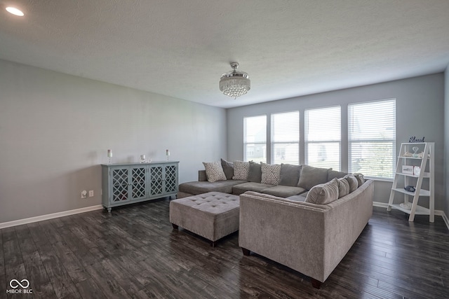 living area featuring baseboards, a textured ceiling, dark wood-style flooring, and recessed lighting