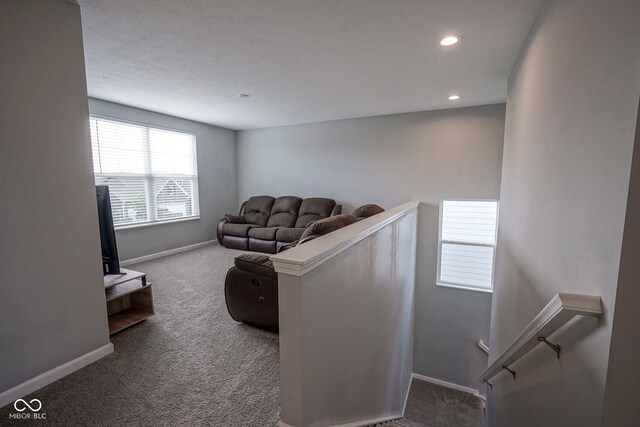 living room featuring carpet floors, baseboards, and recessed lighting