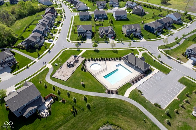 aerial perspective of suburban area featuring a pool area