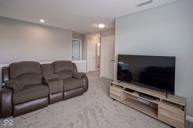 carpeted living room featuring baseboards