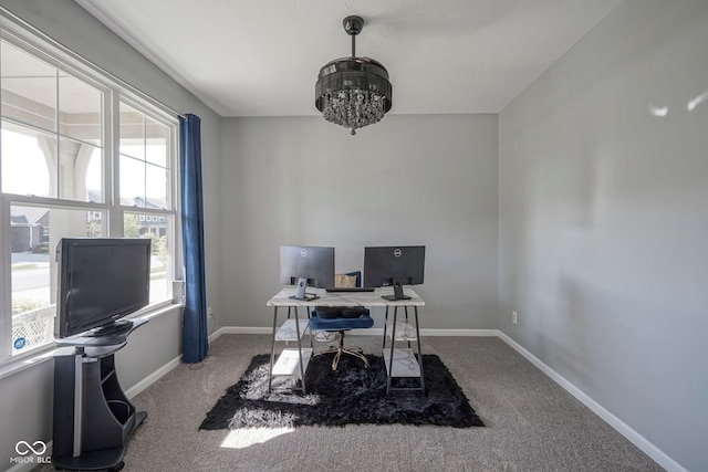 home office with a chandelier, carpet flooring, and baseboards