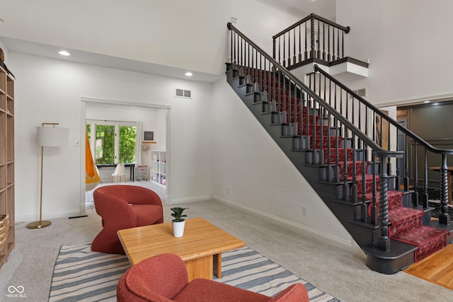 4601 Fairhope Dr, Indianapolis, IN 46237 - living area featuring carpet flooring, a towering ceiling, baseboards, stairway, and recessed lighting