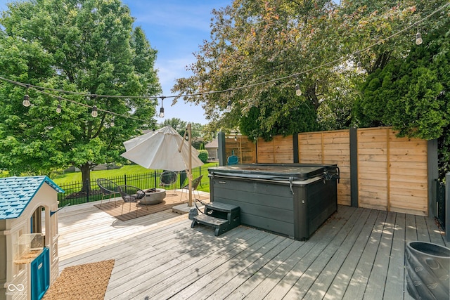 4601 Fairhope Dr, Indianapolis, IN 46237 - wooden deck featuring a hot tub, an outdoor fire pit, and a fenced backyard