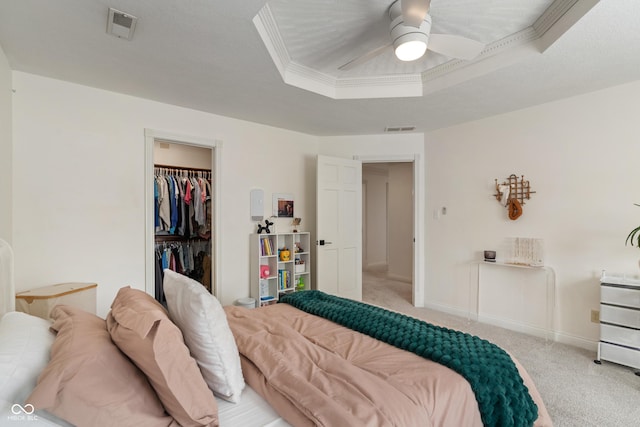 4601 Fairhope Dr, Indianapolis, IN 46237 - bedroom with light colored carpet, a raised ceiling, a closet, a ceiling fan, and a walk in closet