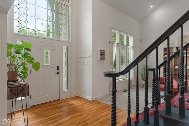 4601 Fairhope Dr, Indianapolis, IN 46237 - entryway with wood finished floors, a high ceiling, baseboards, and stairs