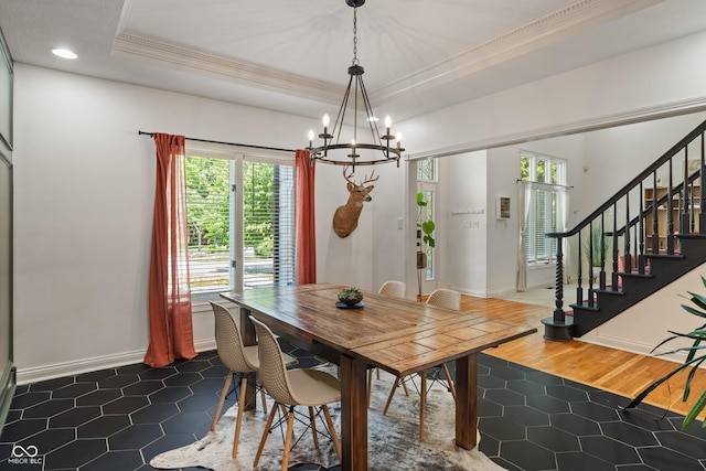 4601 Fairhope Dr, Indianapolis, IN 46237 - dining space featuring ornamental molding, a chandelier, dark tile patterned floors, stairs, and baseboards