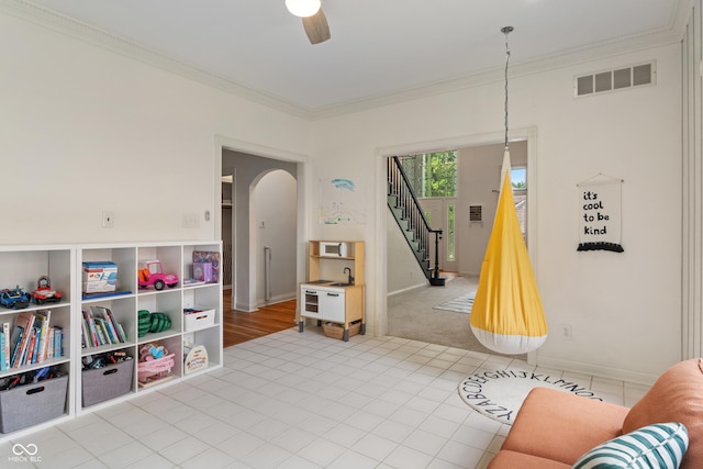 4601 Fairhope Dr, Indianapolis, IN 46237 - living area featuring arched walkways, crown molding, a ceiling fan, stairway, and baseboards