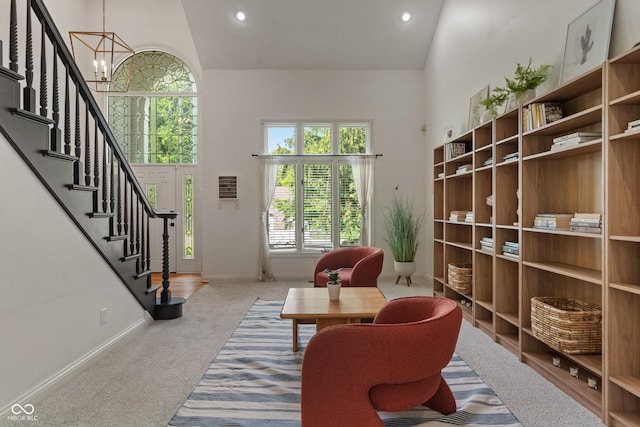 4601 Fairhope Dr, Indianapolis, IN 46237 - carpeted living area featuring a towering ceiling, baseboards, stairway, a chandelier, and recessed lighting