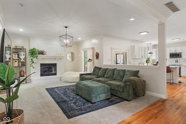 4601 Fairhope Dr, Indianapolis, IN 46237 - living room featuring recessed lighting, ornamental molding, a brick fireplace, light wood-type flooring, and light carpet