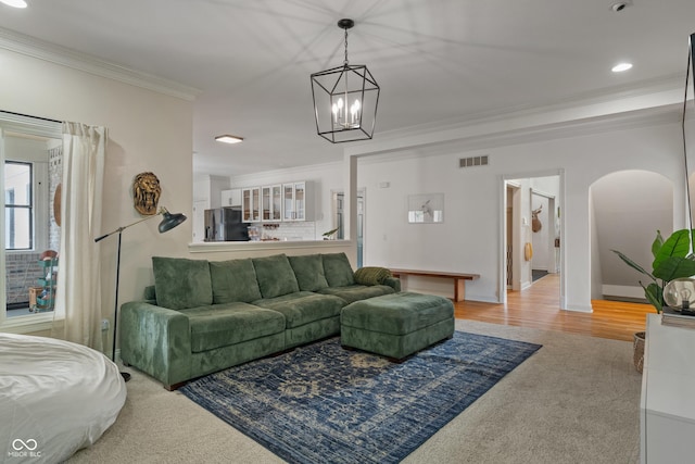 4601 Fairhope Dr, Indianapolis, IN 46237 - carpeted living room with crown molding, a chandelier, recessed lighting, and arched walkways
