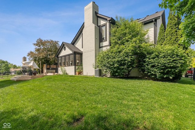 4601 Fairhope Dr, Indianapolis, IN 46237 - view of side of property with a chimney, a sunroom, and cooling unit