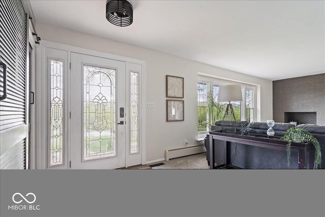 entryway with baseboard heating, carpet, and baseboards