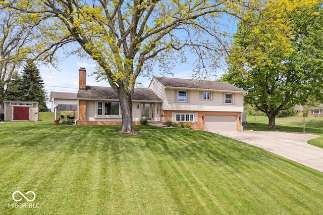 split level home featuring a garage, a chimney, a storage unit, concrete driveway, and brick siding