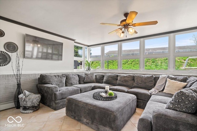 living area with light tile patterned flooring, a ceiling fan, and healthy amount of natural light