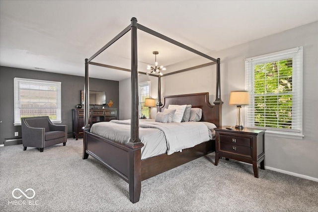 bedroom featuring a chandelier, carpet flooring, multiple windows, and baseboards