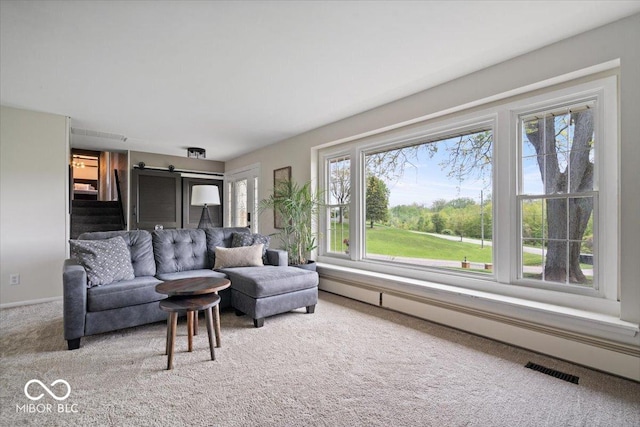 living room with carpet and a baseboard radiator