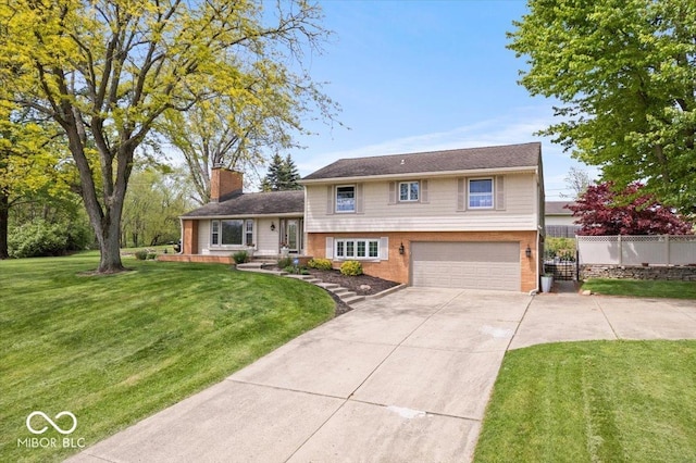 split level home with concrete driveway, brick siding, an attached garage, and a chimney