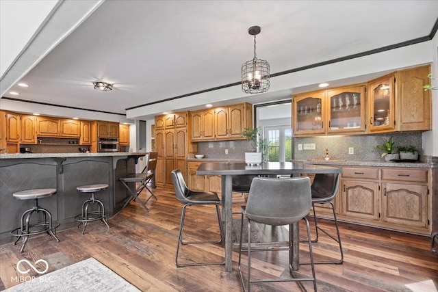 kitchen featuring oven, recessed lighting, glass insert cabinets, tasteful backsplash, and dark wood-style flooring