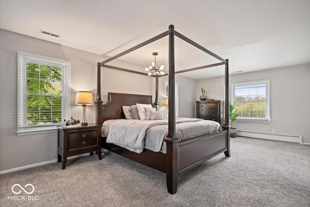 carpeted bedroom featuring baseboard heating, a chandelier, and baseboards