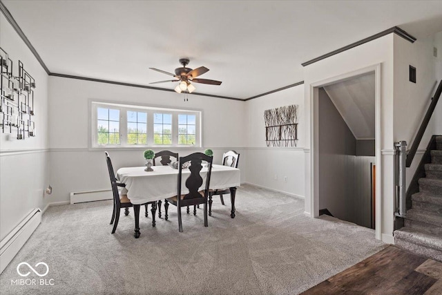 carpeted dining room featuring a baseboard heating unit, stairs, a ceiling fan, ornamental molding, and baseboards