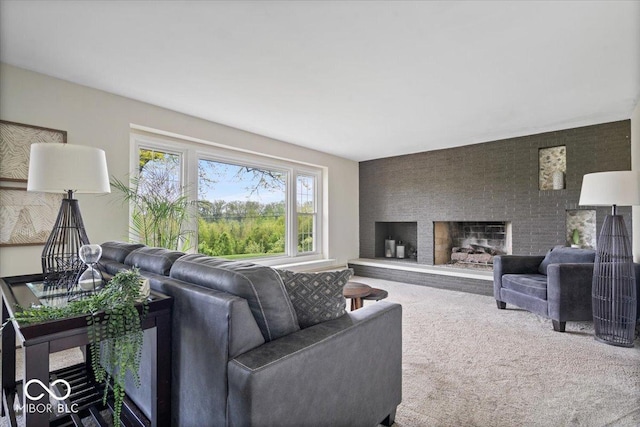 carpeted living area with a large fireplace