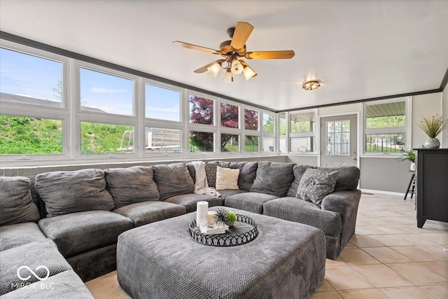 living room featuring light tile patterned floors, baseboards, and ceiling fan