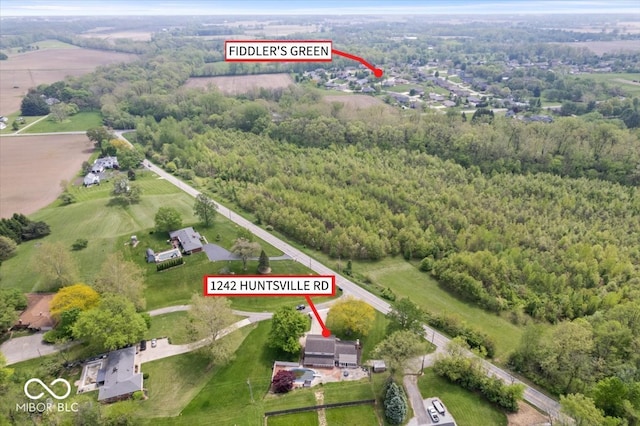 aerial view of property's location with a forest