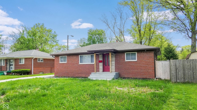 bungalow-style home with brick siding and a chimney