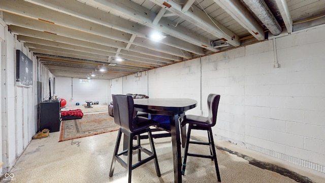unfinished below grade area featuring concrete block wall