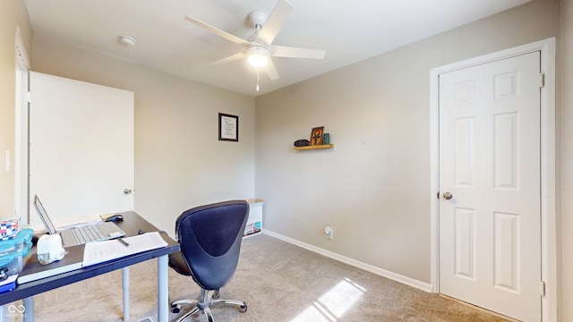 office area featuring carpet flooring, ceiling fan, and baseboards