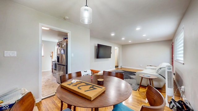 dining room featuring light wood-type flooring, baseboards, and recessed lighting