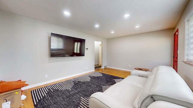 living area with wood finished floors, recessed lighting, and baseboards