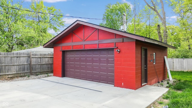 detached garage featuring fence