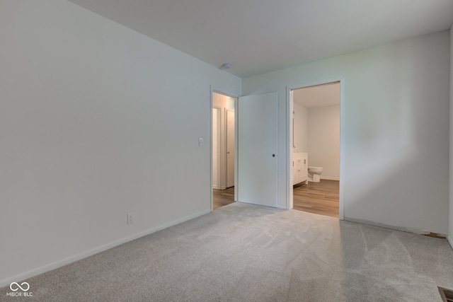 4956 W 11th St, Speedway, IN 46224 - empty room with light carpet and baseboards