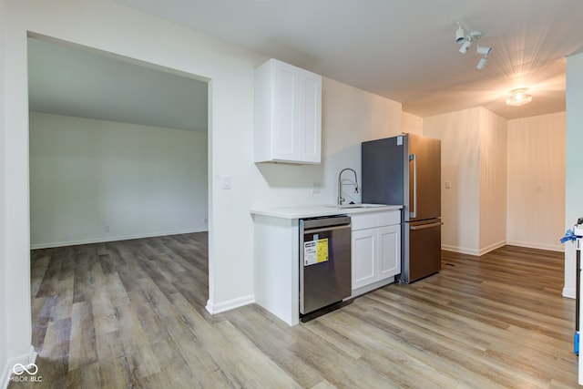 4956 W 11th St, Speedway, IN 46224 - kitchen featuring stainless steel appliances, a sink, light wood-type flooring, and light countertops