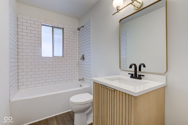 4956 W 11th St, Speedway, IN 46224 - full bath featuring vanity, wood finished floors, toilet, and shower / bath combination