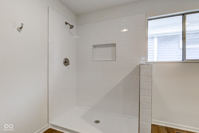 4956 W 11th St, Speedway, IN 46224 - full bath featuring a tile shower, wood finished floors, and baseboards