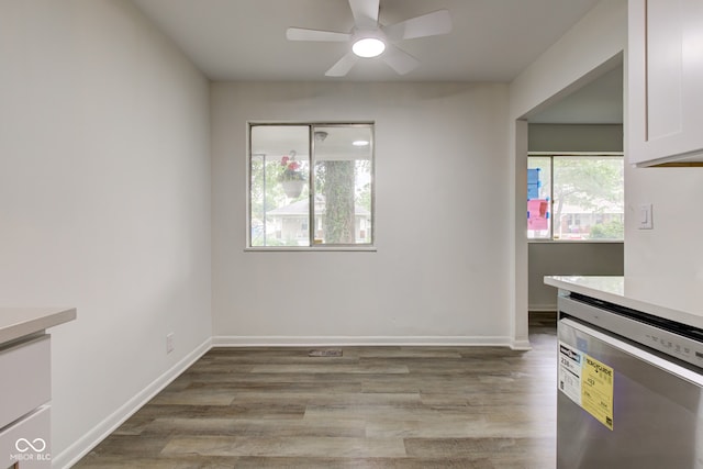 4956 W 11th St, Speedway, IN 46224 - unfurnished dining area with a ceiling fan, light wood finished floors, and baseboards