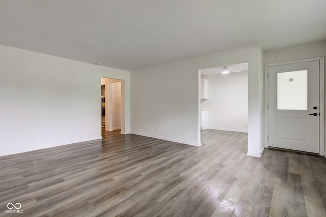 4956 W 11th St, Speedway, IN 46224 - unfurnished living room featuring wood finished floors, baseboards, and a ceiling fan