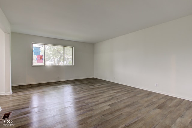 4956 W 11th St, Speedway, IN 46224 - spare room featuring dark wood finished floors and baseboards