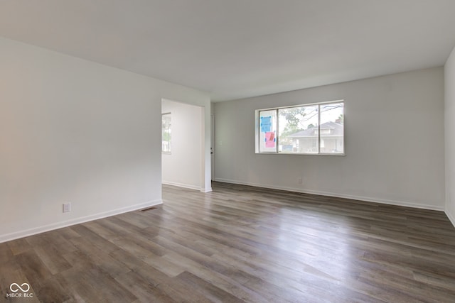 4956 W 11th St, Speedway, IN 46224 - spare room with dark wood finished floors and baseboards
