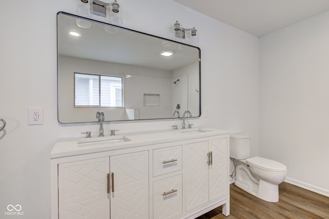 4956 W 11th St, Speedway, IN 46224 - full bath with toilet, double vanity, wood finished floors, and baseboards