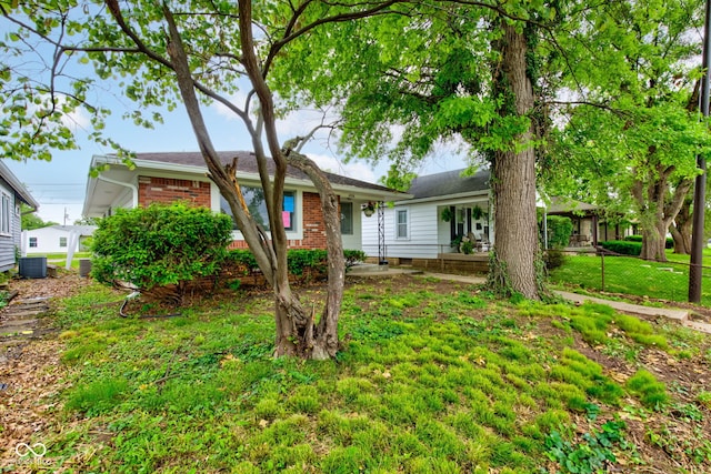 4956 W 11th St, Speedway, IN 46224 - ranch-style house with brick siding, cooling unit, and a front yard
